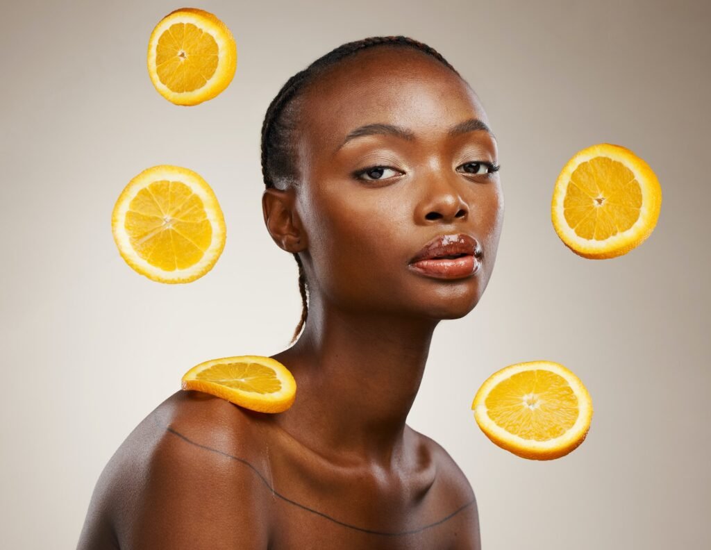 Black woman, skincare or facial treatment with orange, beauty and cosmetics for healthy skin, vitam