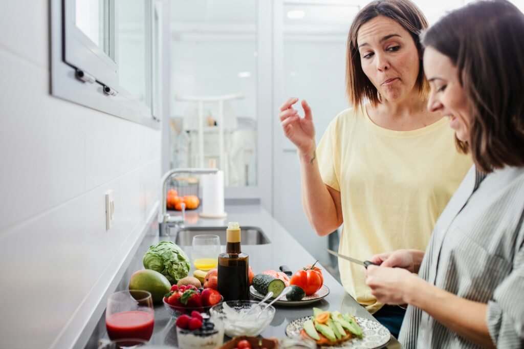 Women preparing healthy food in kitchen having fun, concept dieting nutrition.