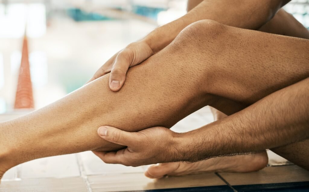 Legs injury, swimming and sports person massage calf problem from exercise, training or workout cri