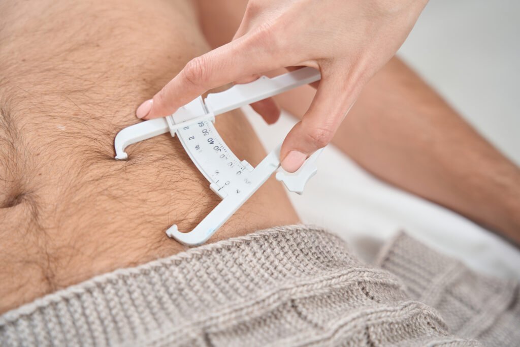 Patient is measured level of fat in body with caliper